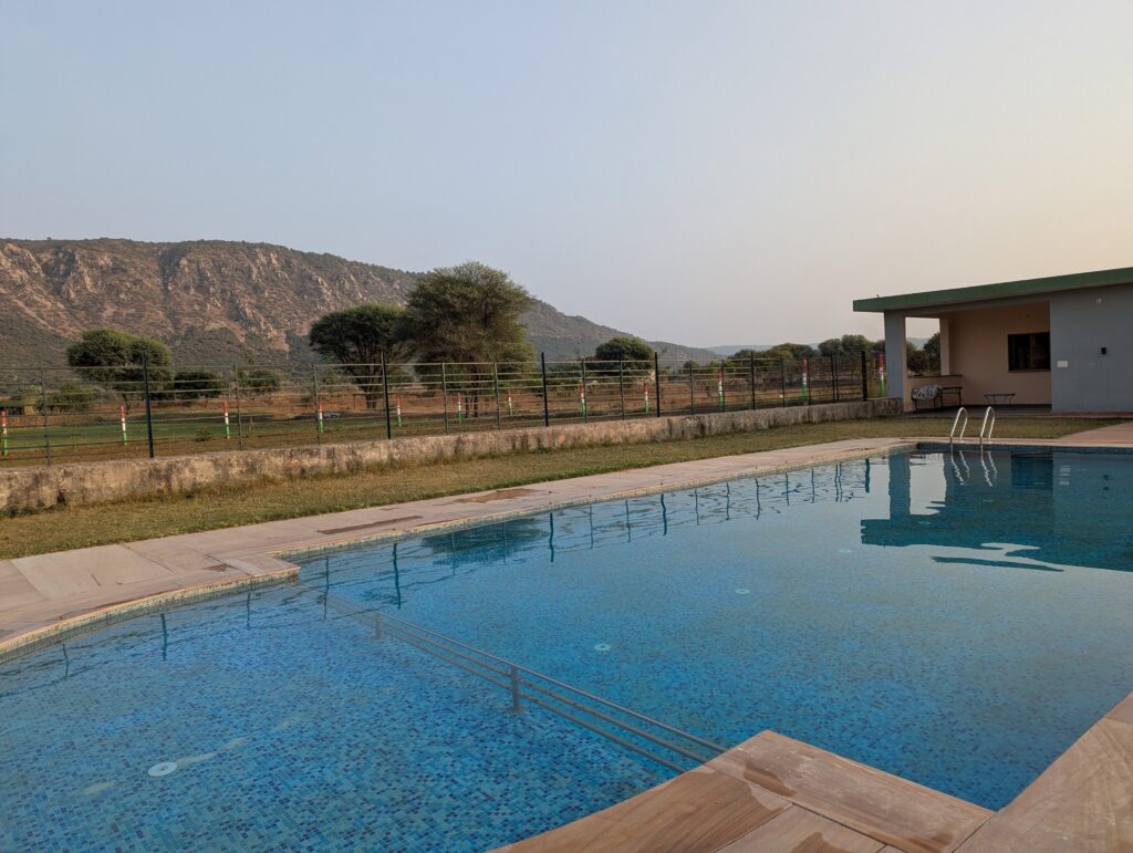 Swimming pool with the backdrop of Aravali mountains
